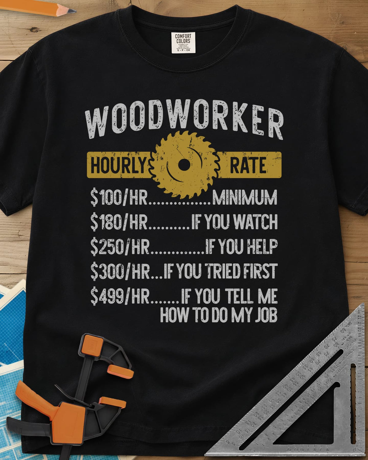 Woodworker Hourly Rate heavyweight tee in Black, a rate sheet with a gold saw blade banner and gag hourly tiers
