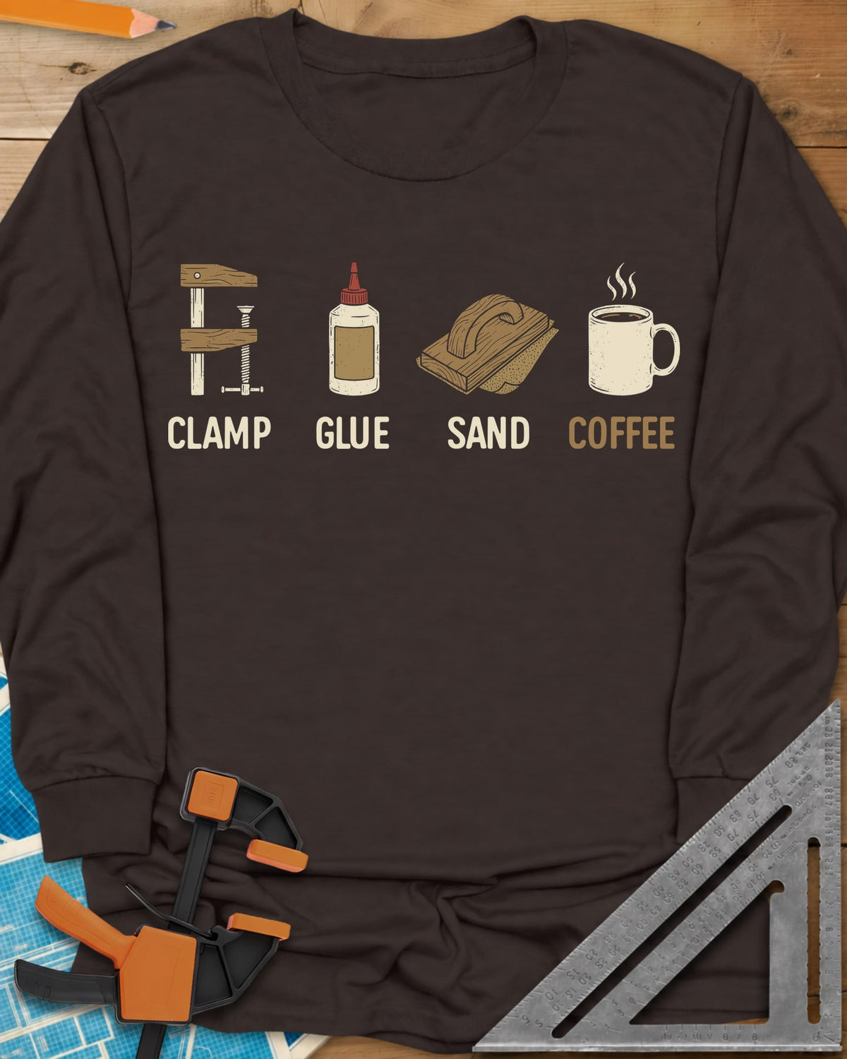 Woodworker's Essentials long sleeve shirt in Dark Chocolate, a bar clamp, glue bottle, sanding block and mug, each captioned