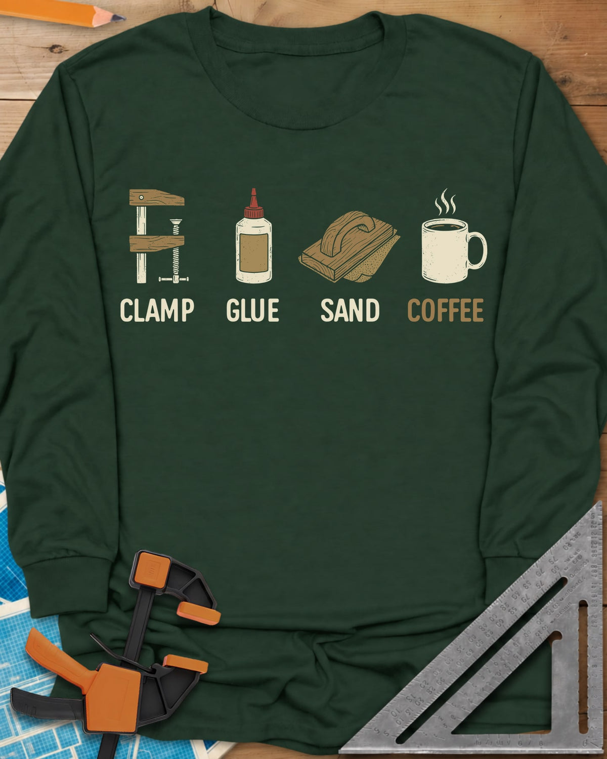 Woodworker's Essentials long sleeve shirt in Forest Green, a bar clamp, glue bottle, sanding block and mug, each captioned