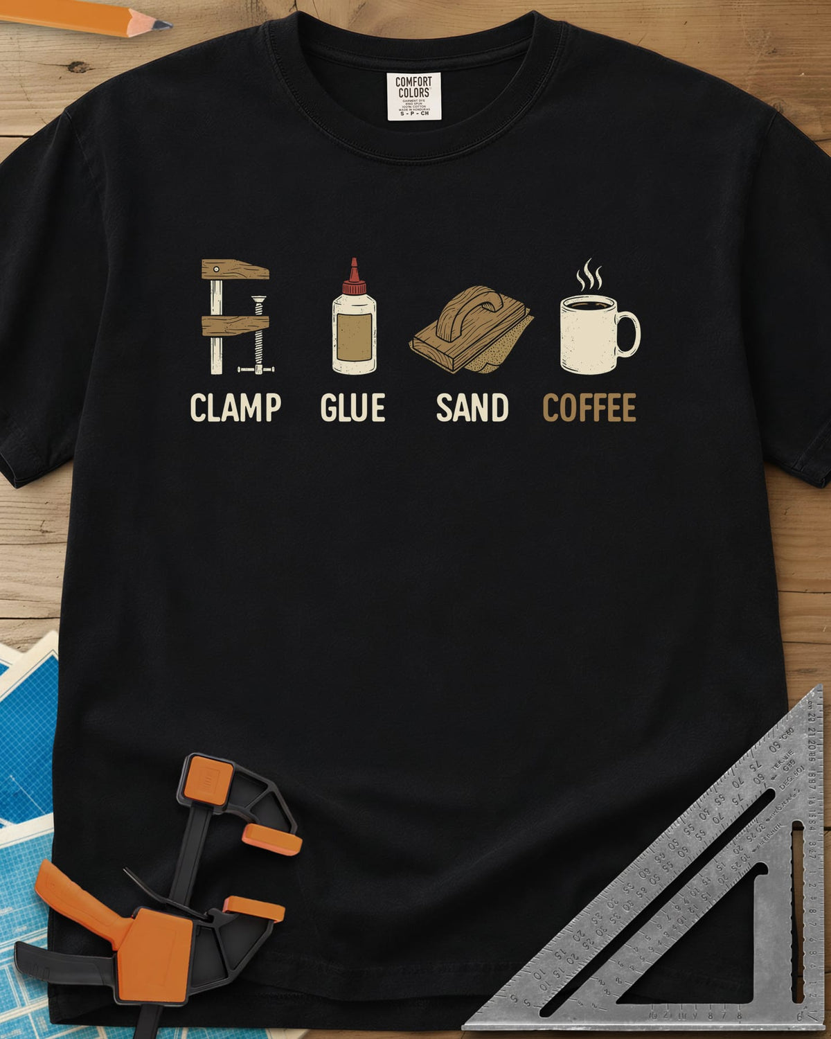 Woodworker's Essentials heavyweight tee in Black, a bar clamp, glue bottle, sanding block and mug, each captioned