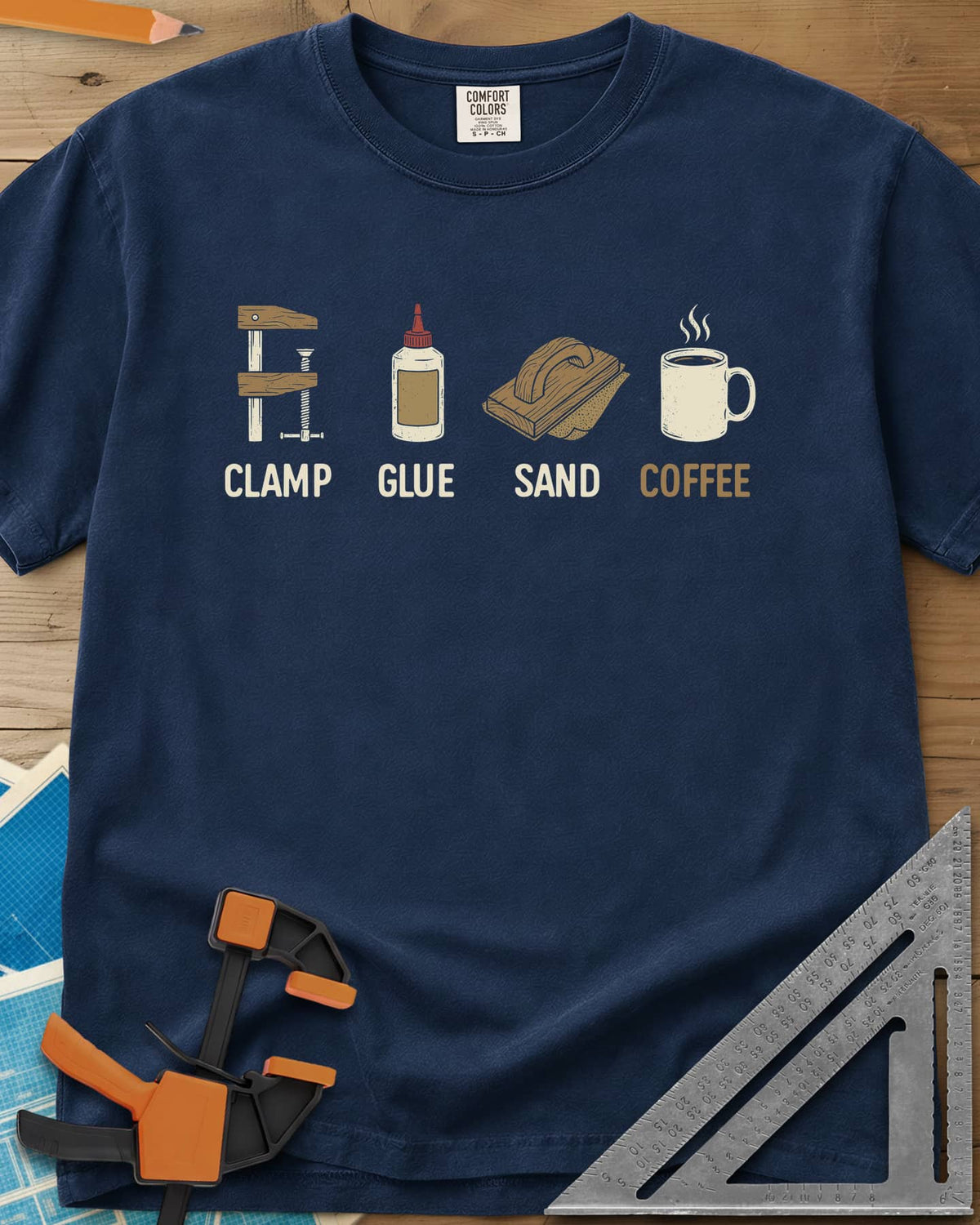 Woodworker's Essentials heavyweight tee in Navy, a bar clamp, glue bottle, sanding block and mug, each captioned