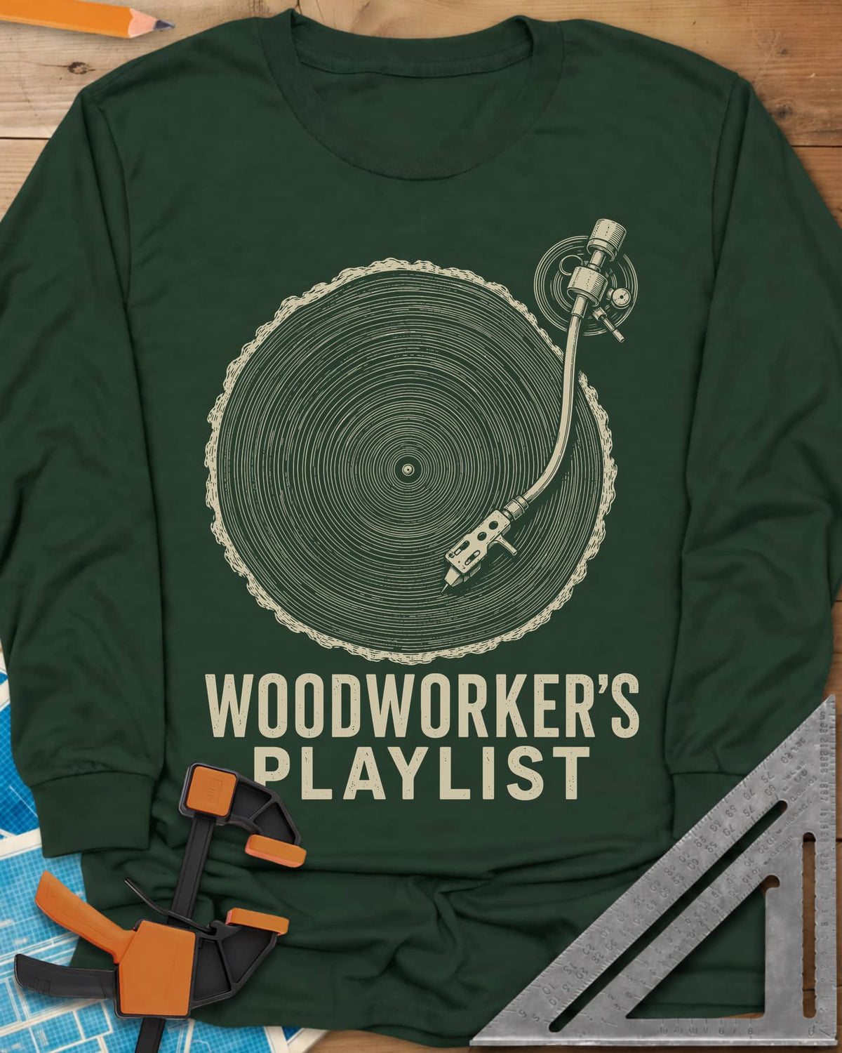 Woodworker’s Playlist long sleeve shirt in Forest Green, tree-ring slice as a vinyl record with a turntable tonearm