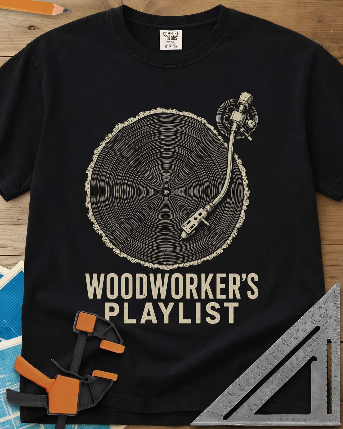 Woodworker’s Playlist heavyweight tee in Black, tree-ring slice as a vinyl record with a turntable tonearm