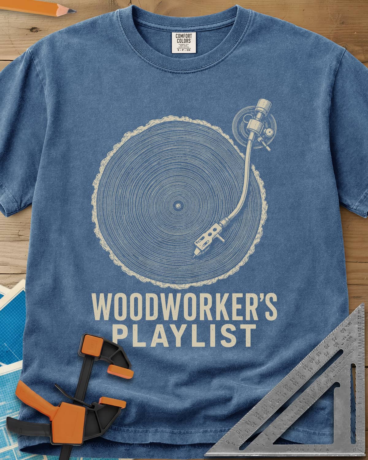 Woodworker’s Playlist heavyweight tee in Blue Jean, tree-ring slice as a vinyl record with a turntable tonearm