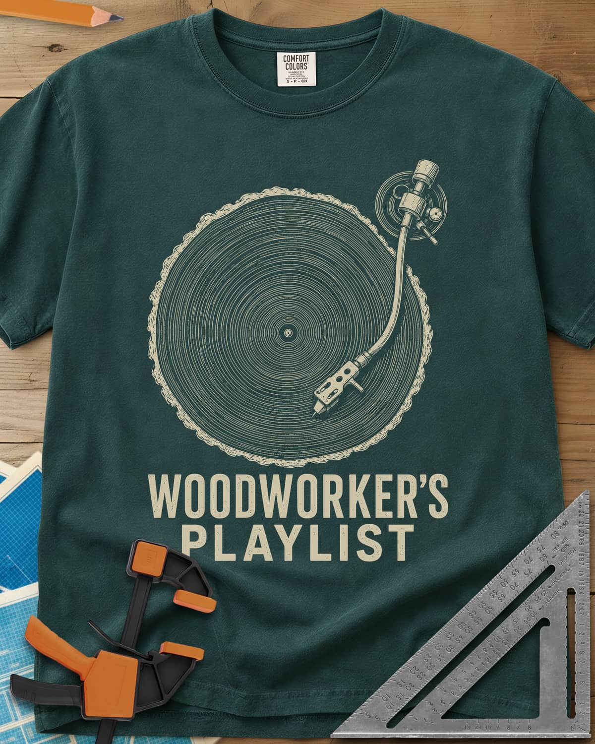 Woodworker’s Playlist heavyweight tee in Blue Spruce, tree-ring slice as a vinyl record with a turntable tonearm