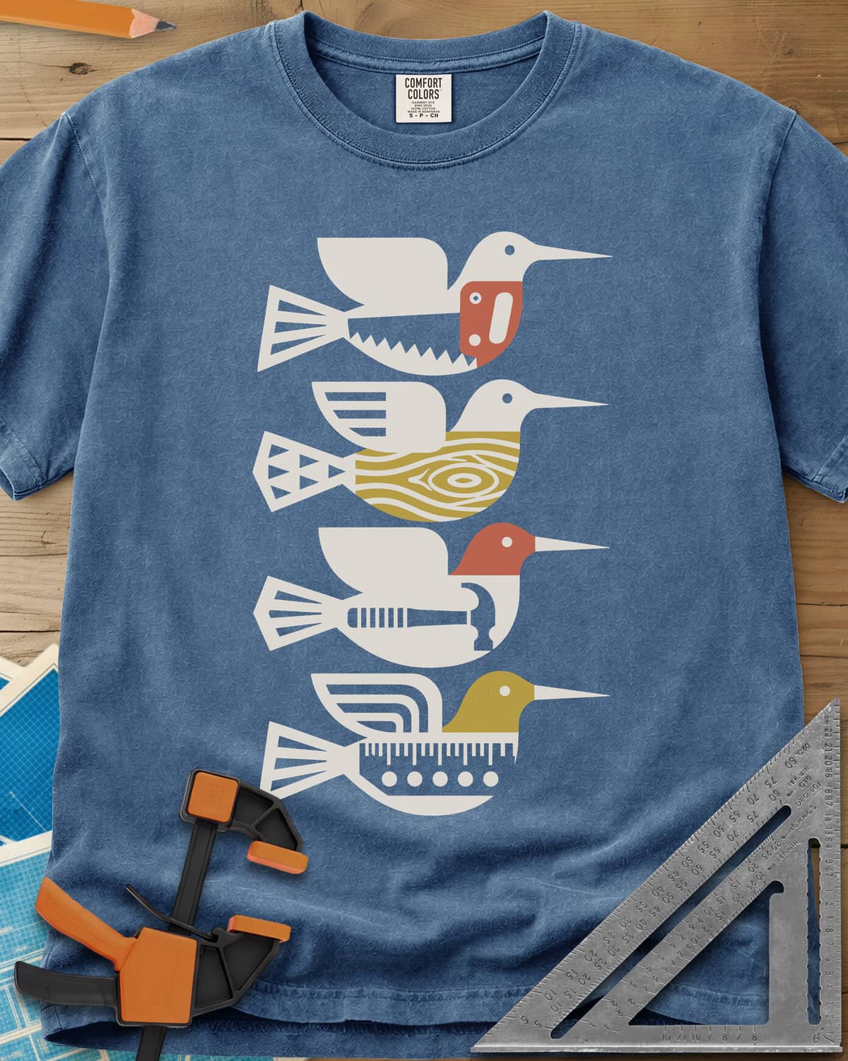 Woodworking Birds heavyweight tee in Blue Jean, four stacked birds built from a saw, wood grain, hammer and ruler