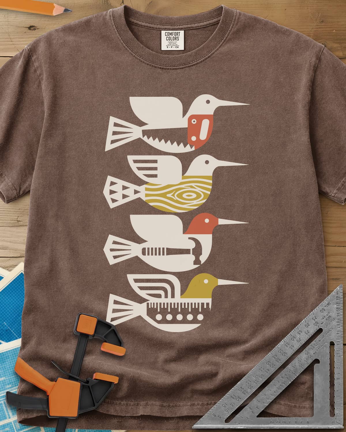 Woodworking Birds heavyweight tee in Espresso, four stacked birds built from a saw, wood grain, hammer and ruler