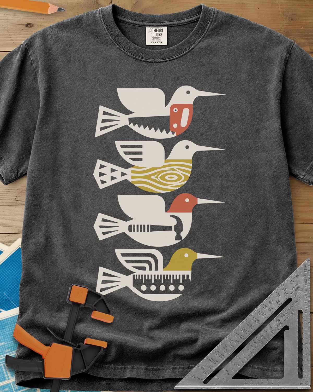 Woodworking Birds heavyweight tee in Pepper, four stacked birds built from a saw, wood grain, hammer and ruler