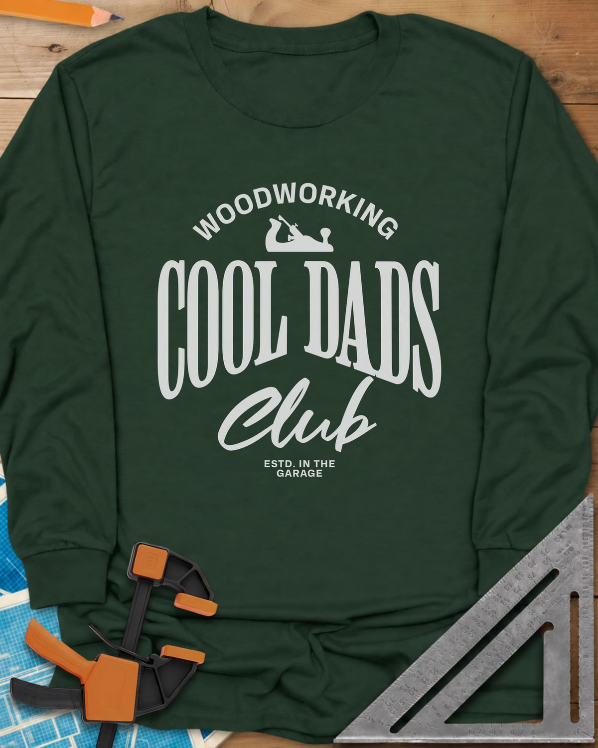 Woodworking Cool Dads long sleeve shirt in Forest Green, club-style lettering with a small hand plane silhouette