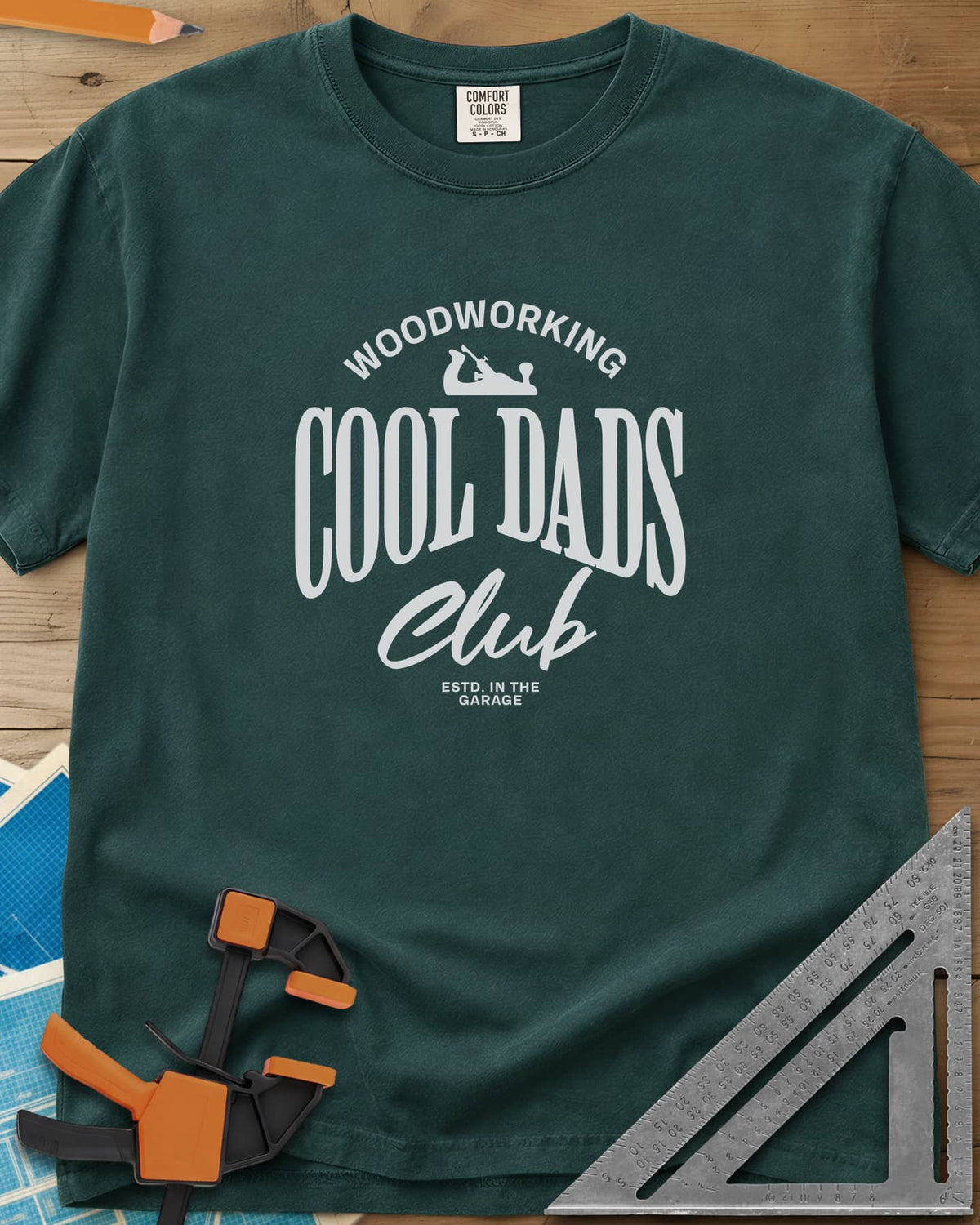 Woodworking Cool Dads heavyweight tee in Blue Spruce, club-style lettering with a small hand plane silhouette