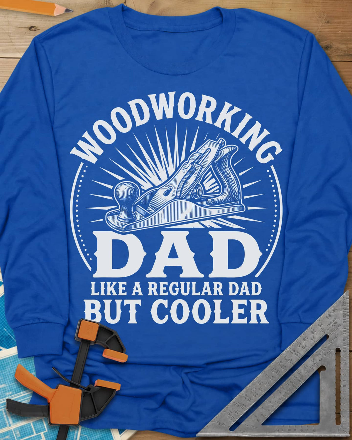 Woodworking Dad But Cooler long sleeve shirt in Royal, an engraved hand plane in a sunburst circle