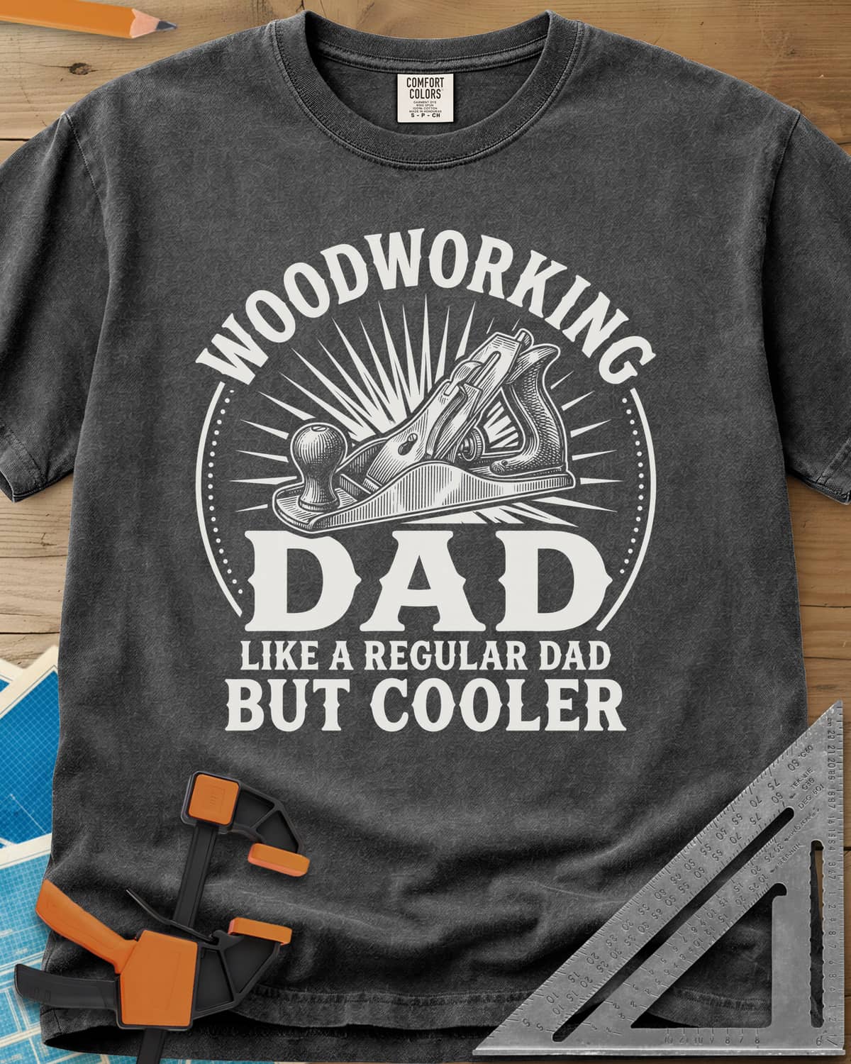 Woodworking Dad But Cooler heavyweight tee in Pepper, an engraved hand plane in a sunburst circle
