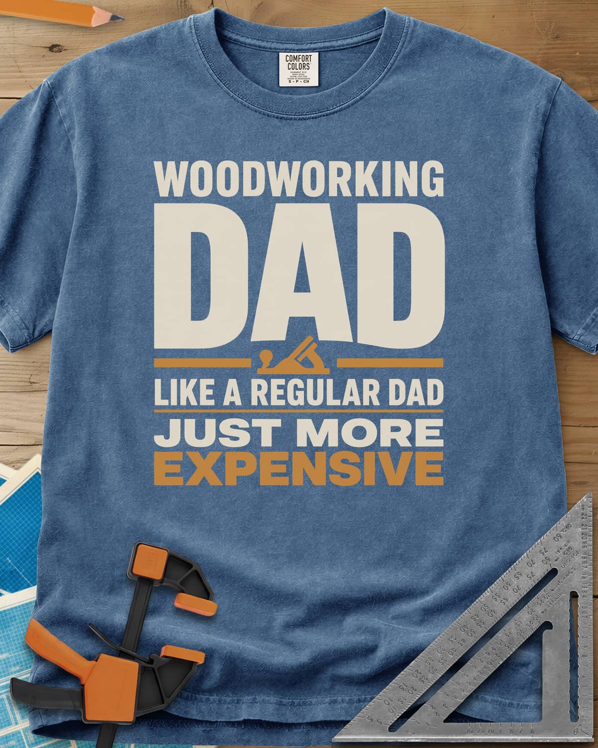Woodworking Dad Just More Expensive heavyweight tee in Blue Jean, bold lettering with a small hand plane tucked under DAD