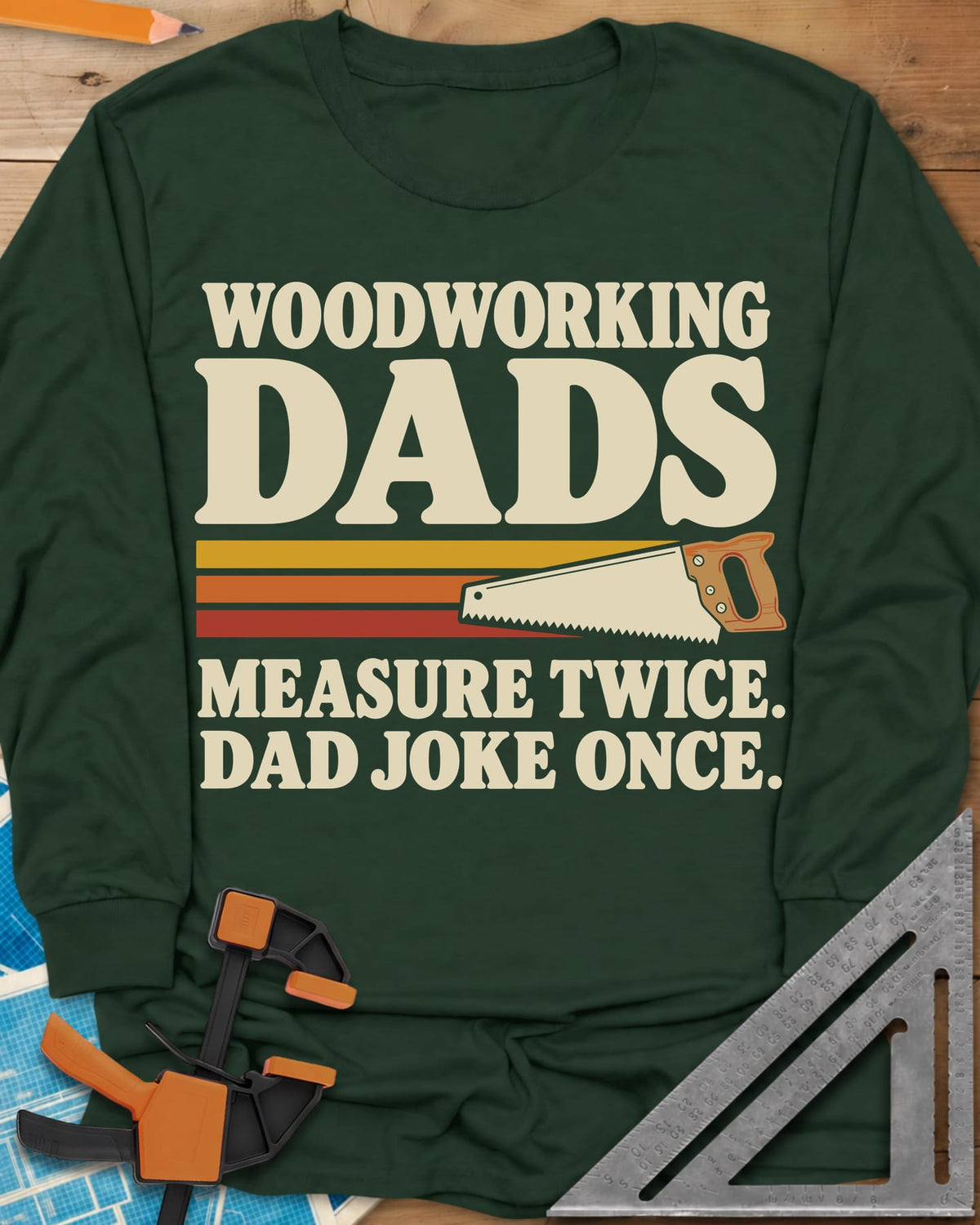 Woodworking Dads long sleeve shirt in Forest Green, retro stripes trailing a hand saw under bold type