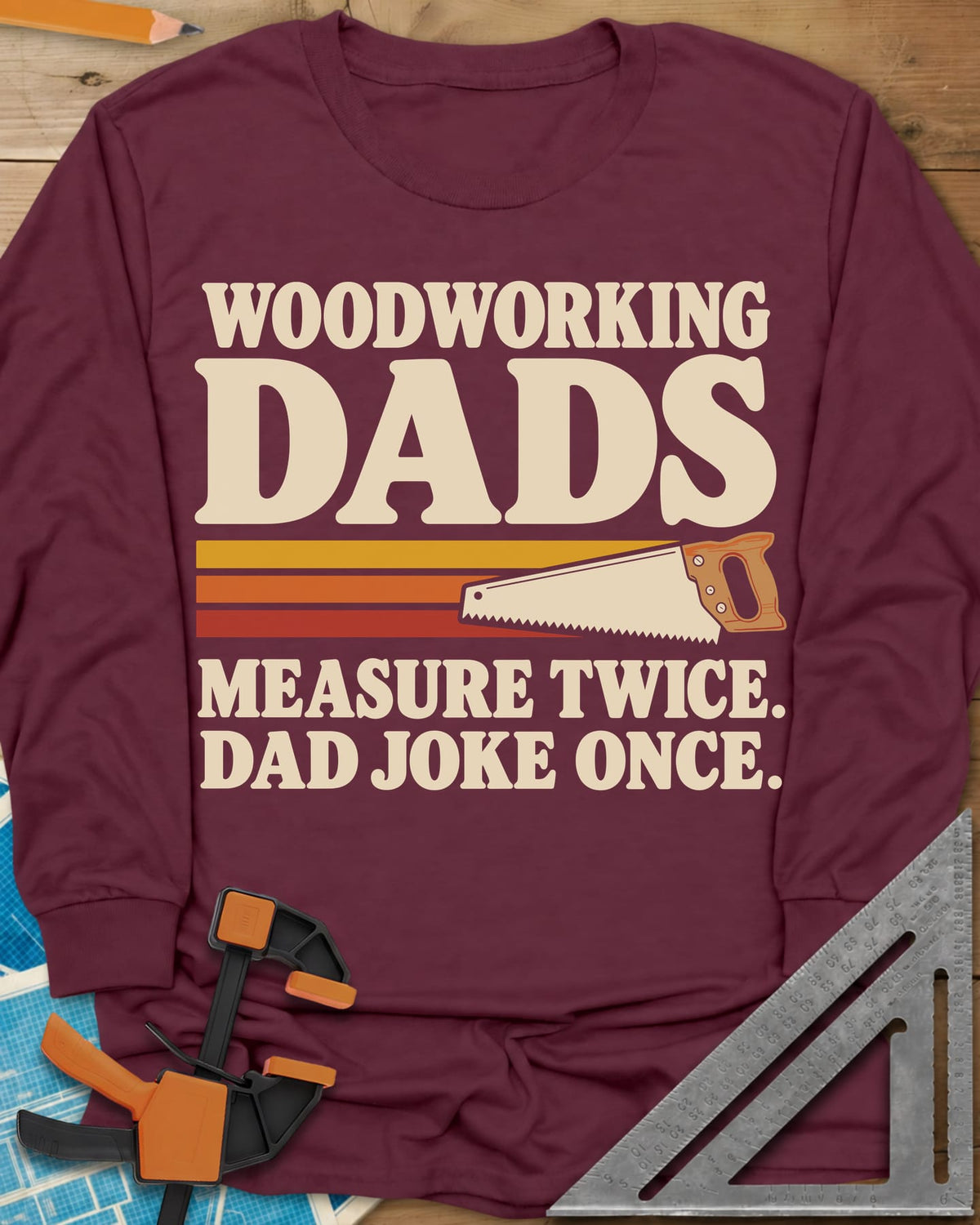 Woodworking Dads long sleeve shirt in Maroon, retro stripes trailing a hand saw under bold type