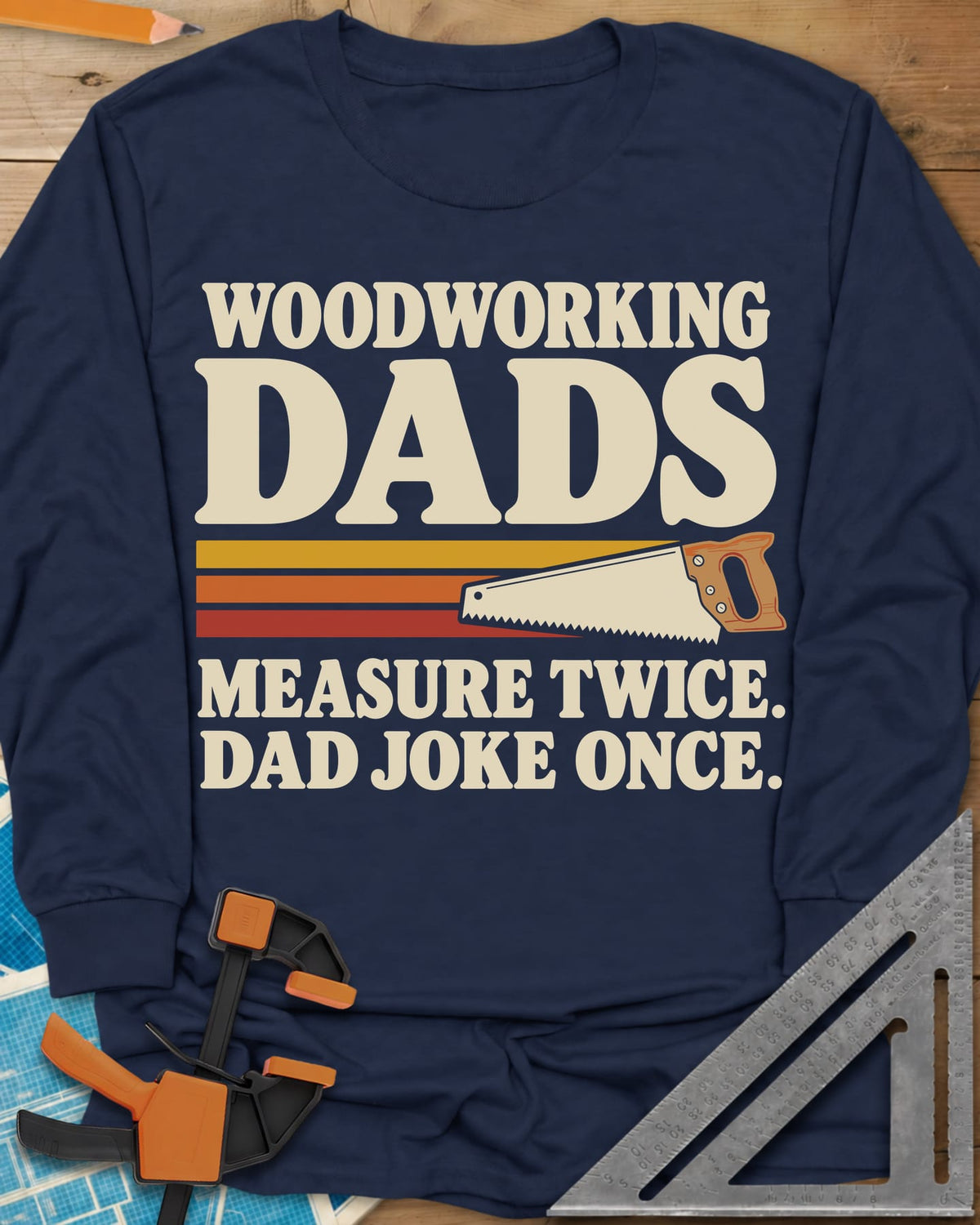 Woodworking Dads long sleeve shirt in Navy, retro stripes trailing a hand saw under bold type