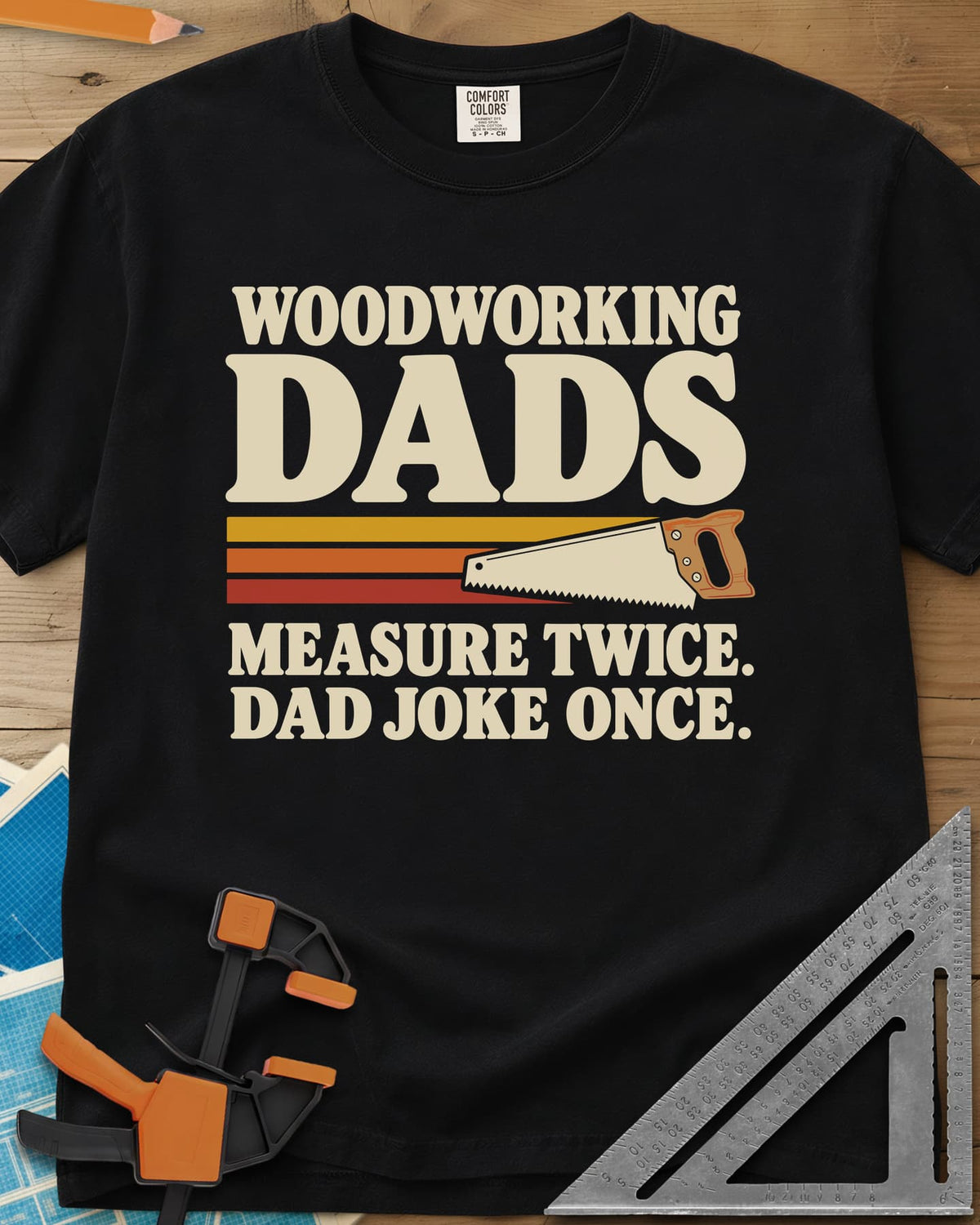 Woodworking Dads heavyweight tee in Black, retro stripes trailing a hand saw under bold type
