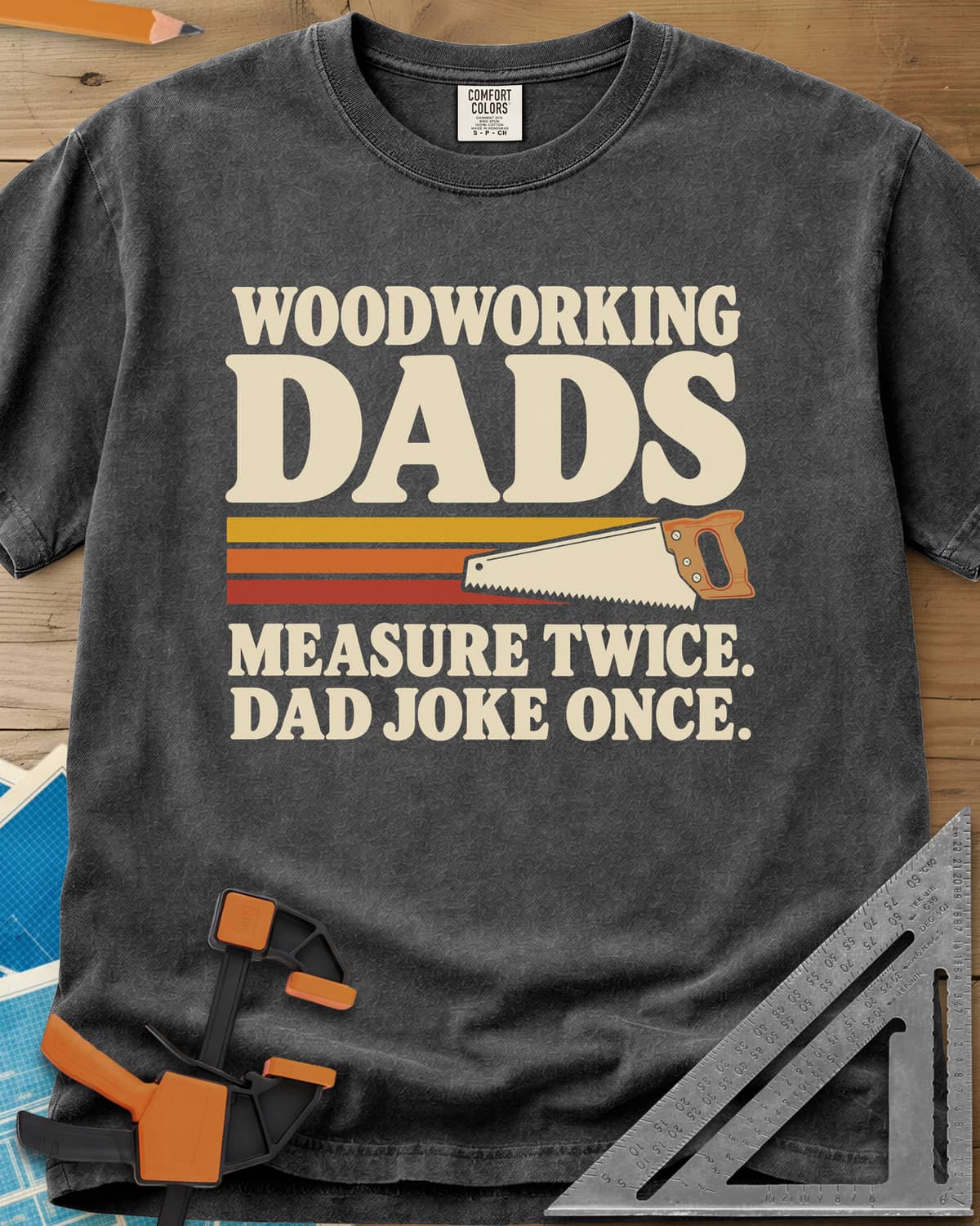 Woodworking Dads heavyweight tee in Pepper, retro stripes trailing a hand saw under bold type