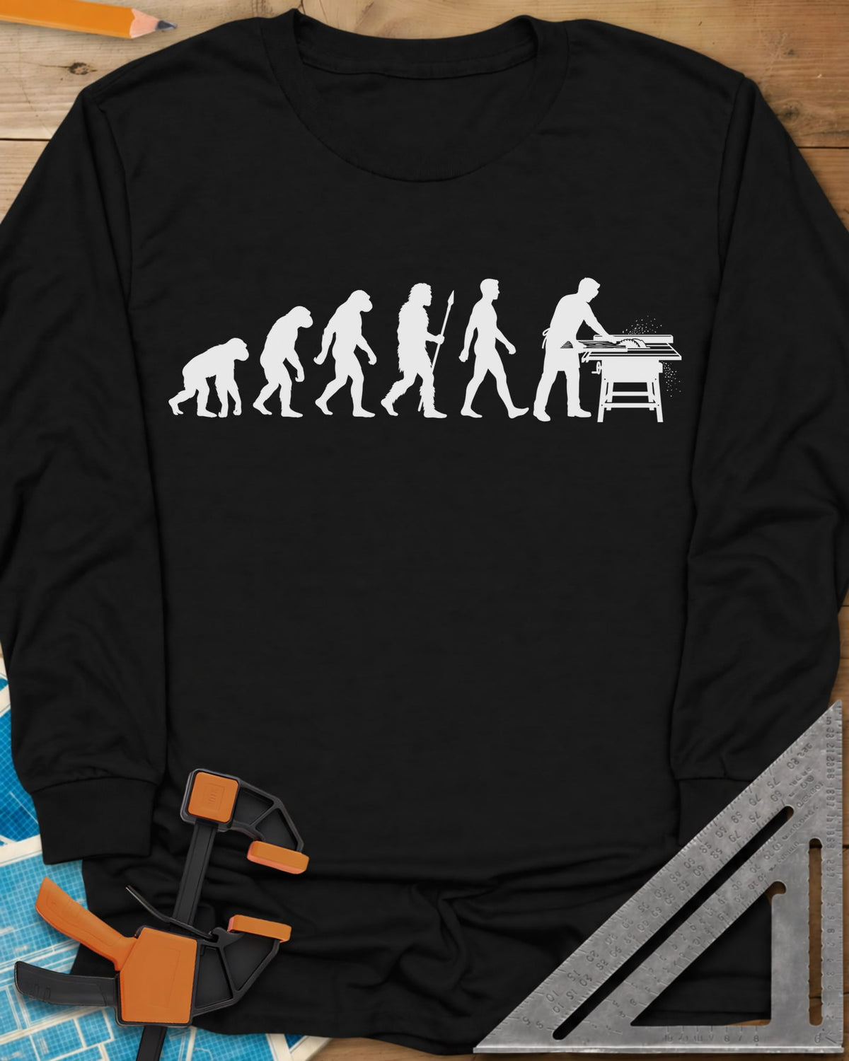 Woodworking Evolution long sleeve shirt in Black, six white silhouettes from an ape to a man at a table saw