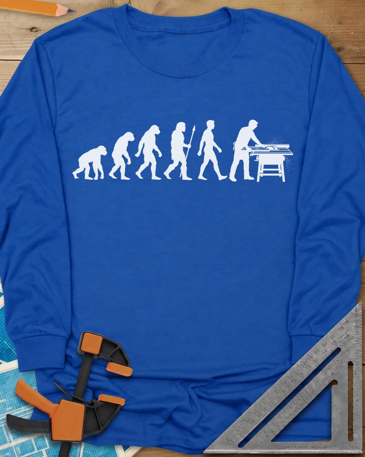 Woodworking Evolution long sleeve shirt in Royal, six white silhouettes from an ape to a man at a table saw