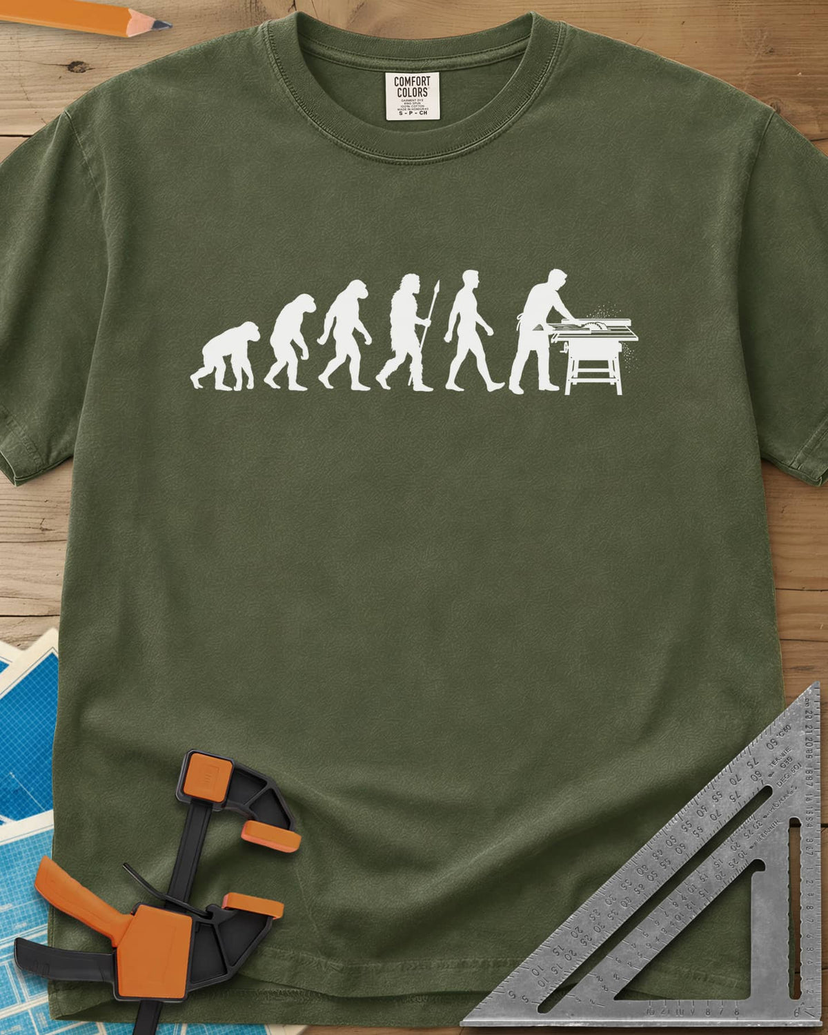 Woodworking Evolution heavyweight tee in Hemp, six white silhouettes from an ape to a man at a table saw