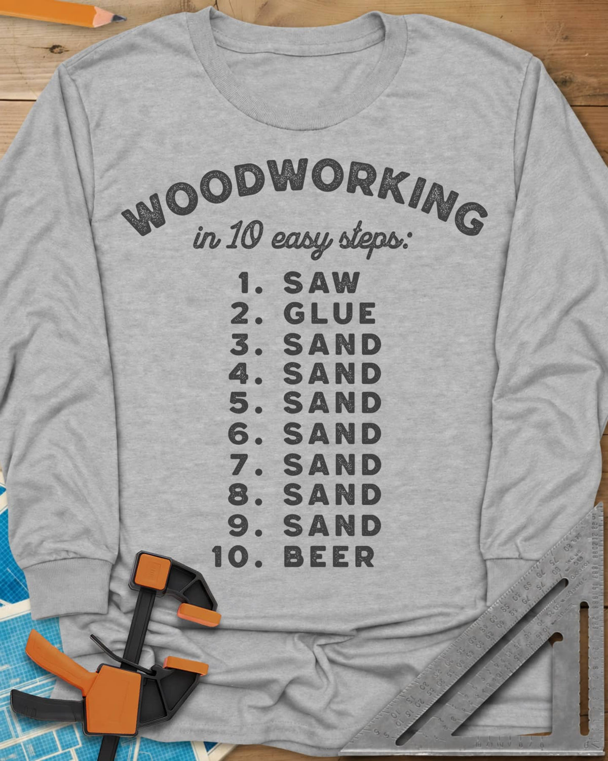Woodworking in 10 Easy Steps long sleeve shirt in Sport Grey, a numbered list: saw, glue, sand seven times, then beer