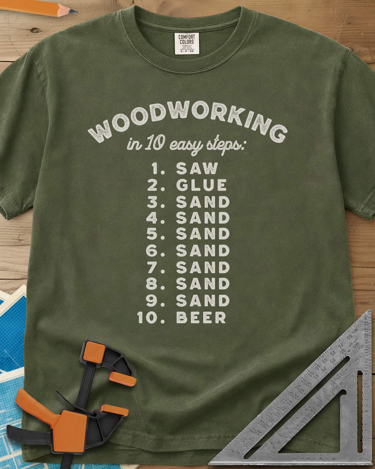 Woodworking in 10 Easy Steps heavyweight tee in Hemp, a numbered list: saw, glue, sand seven times, then beer