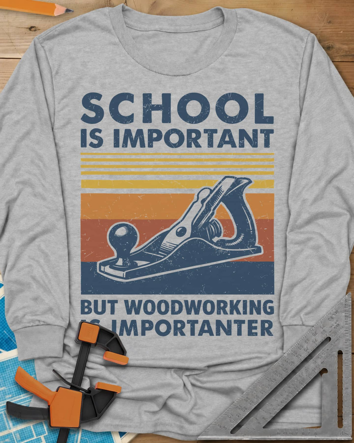 Woodworking is Importanter long sleeve shirt in Sport Grey, a vintage hand plane over retro sunset stripes