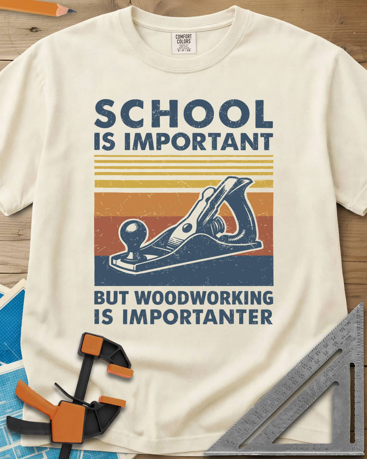 Woodworking is Importanter heavyweight tee in Ivory, a vintage hand plane over retro sunset stripes