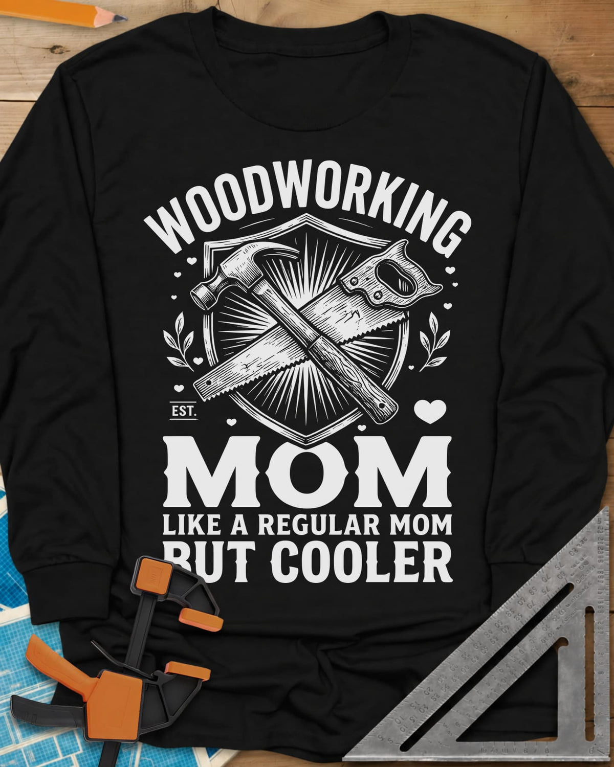 Woodworking Mom long sleeve shirt in Black, a hammer and hand saw crossed on a shield with hearts and leaves