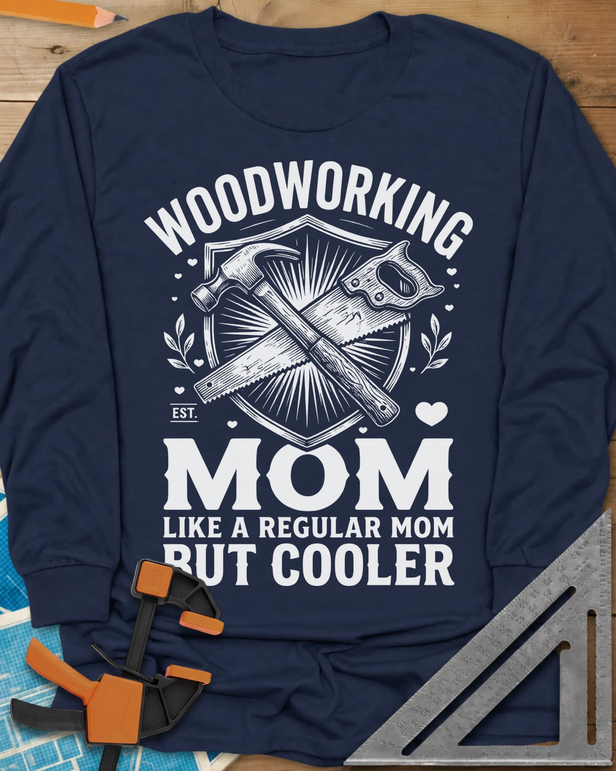 Woodworking Mom long sleeve shirt in Navy, a hammer and hand saw crossed on a shield with hearts and leaves