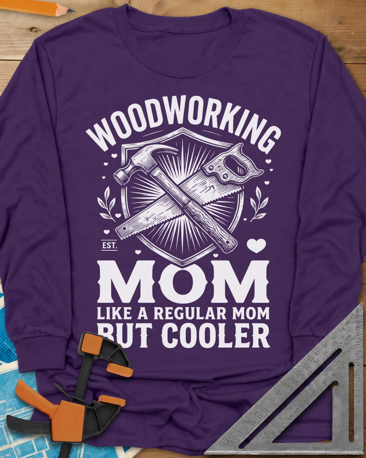 Woodworking Mom long sleeve shirt in Purple, a hammer and hand saw crossed on a shield with hearts and leaves