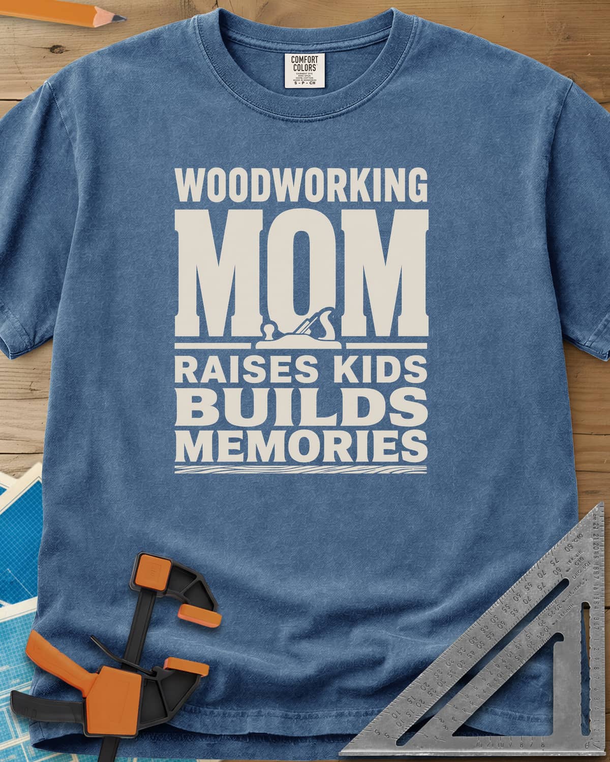 Woodworking Mom Memories heavyweight tee in Blue Jean, bold stacked lettering with a hand plane set into the O of MOM