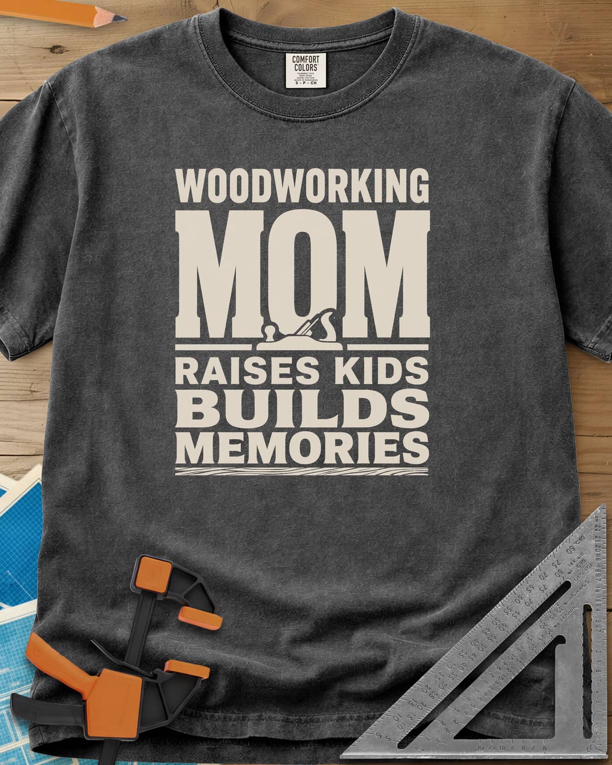 Woodworking Mom Memories heavyweight tee in Pepper, bold stacked lettering with a hand plane set into the O of MOM
