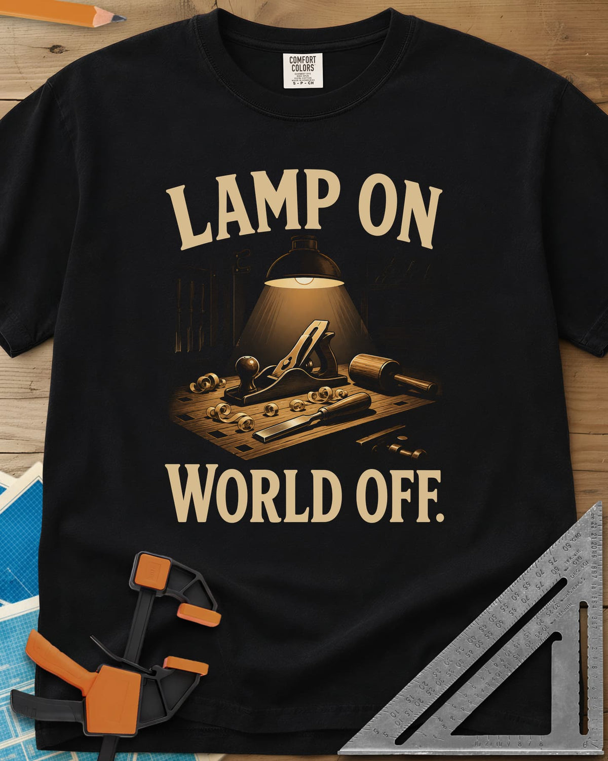 Workbench Lamp heavyweight tee in Black, a shop lamp over a bench with plane, chisel and shavings