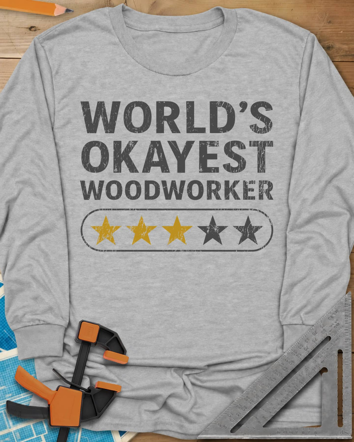 World’s Okayest Woodworker long sleeve shirt in Sport Grey, block letters above a five-star bar with three stars filled