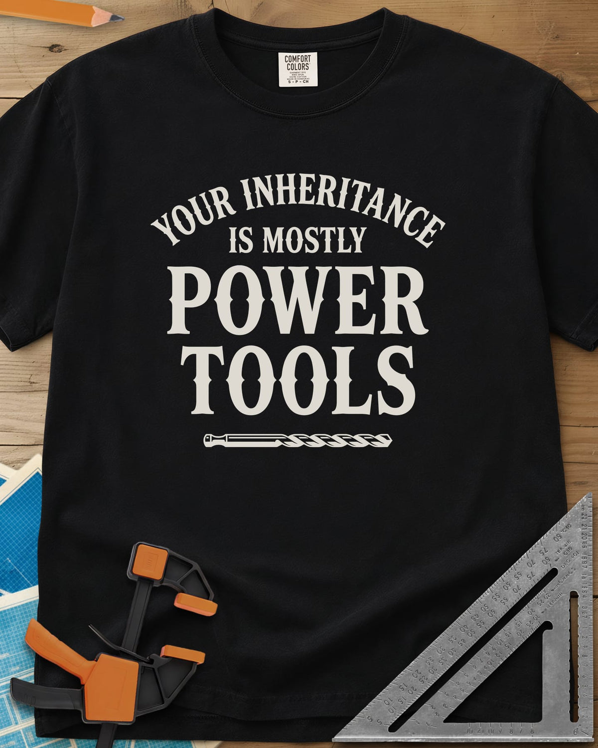 Your Inheritance Is Mostly Power Tools heavyweight tee in Black, arched serif lettering over a drill bit underline