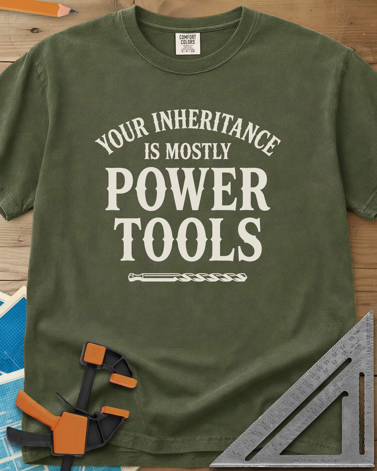Your Inheritance Is Mostly Power Tools heavyweight tee in Hemp, arched serif lettering over a drill bit underline