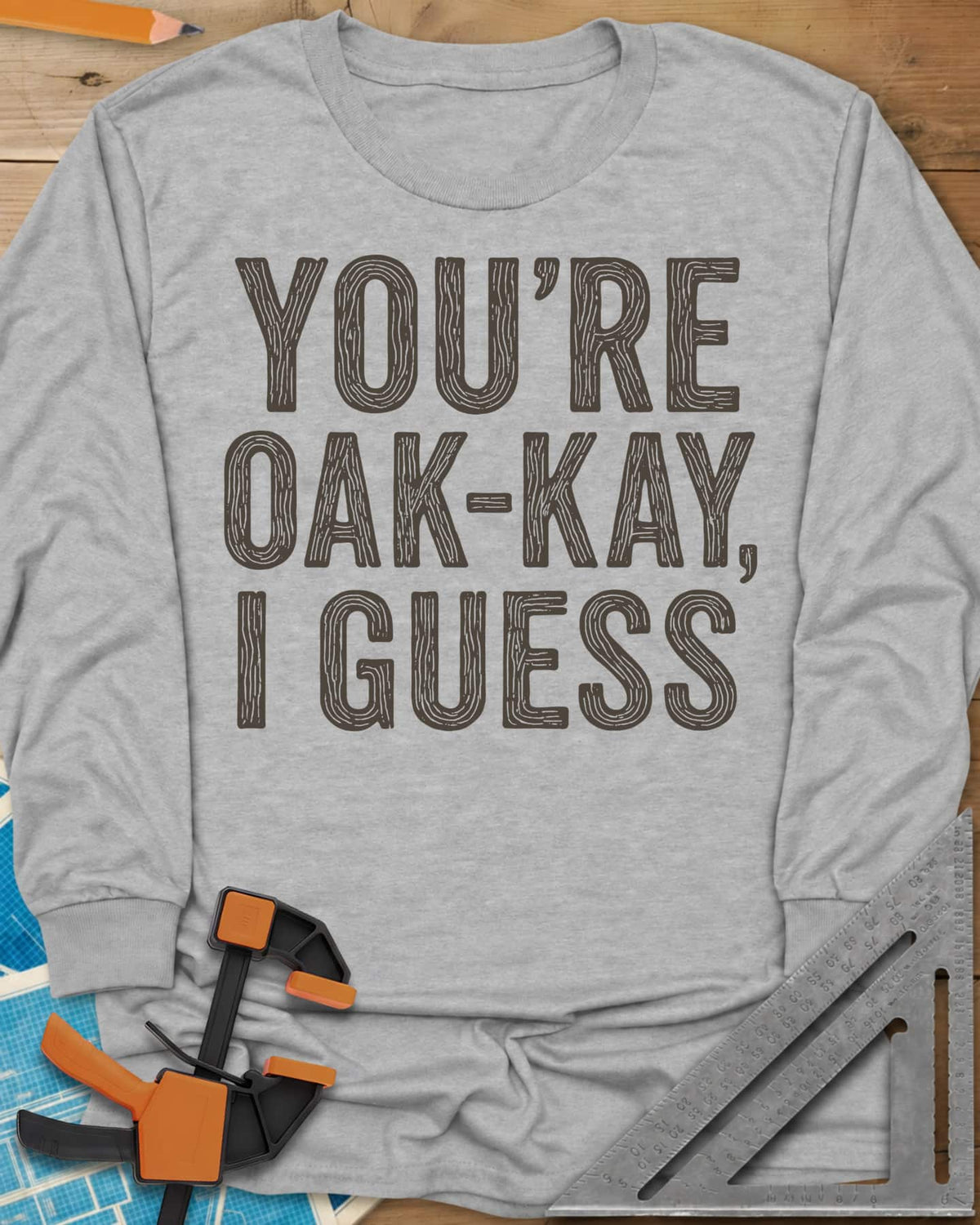 You're Oak-Kay long sleeve shirt in Sport Grey, tall block letters filled with wood-grain lines