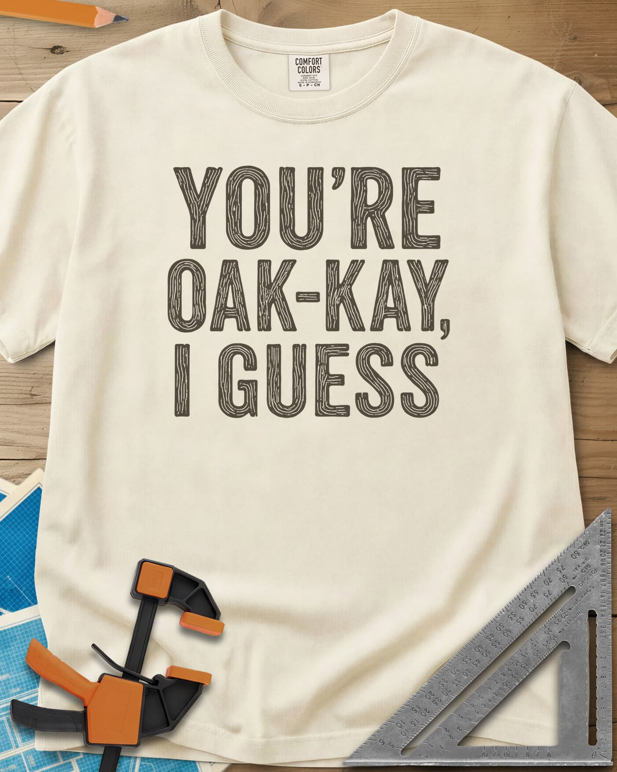 You're Oak-Kay heavyweight tee in Ivory, tall block letters filled with wood-grain lines