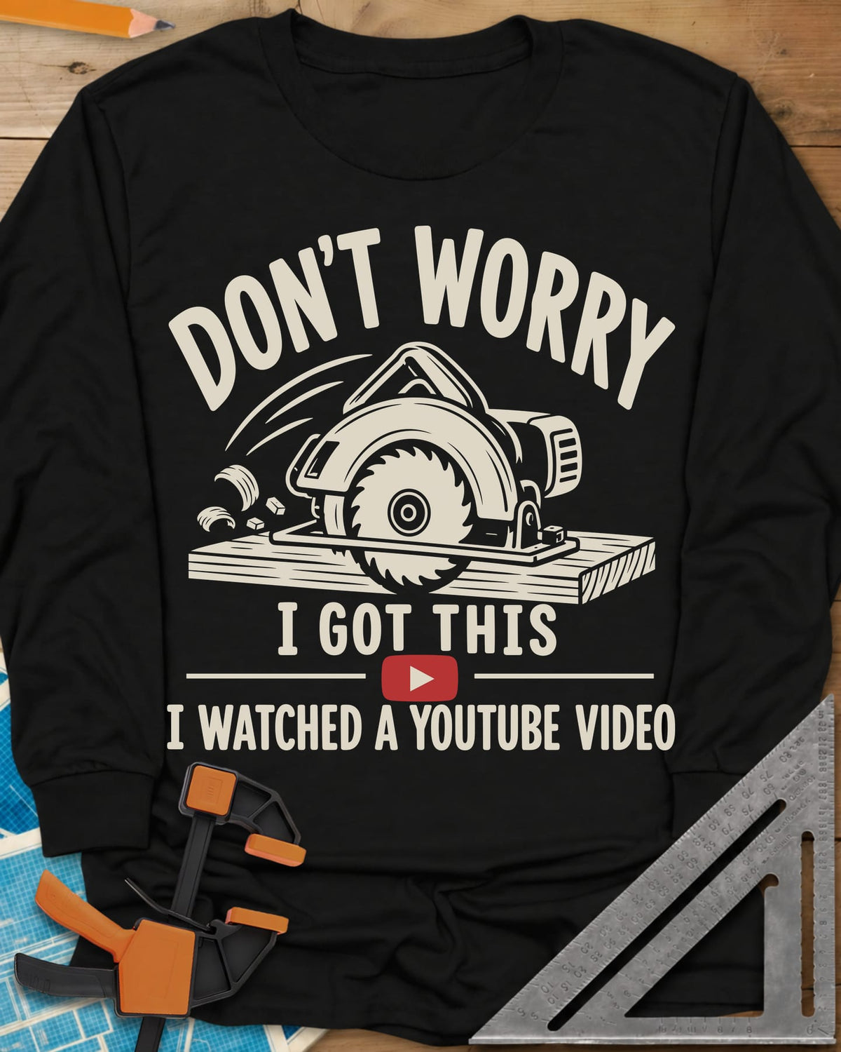 YouTube Pro long sleeve shirt in Black, a circular saw cutting a plank with flying chips and a red play button