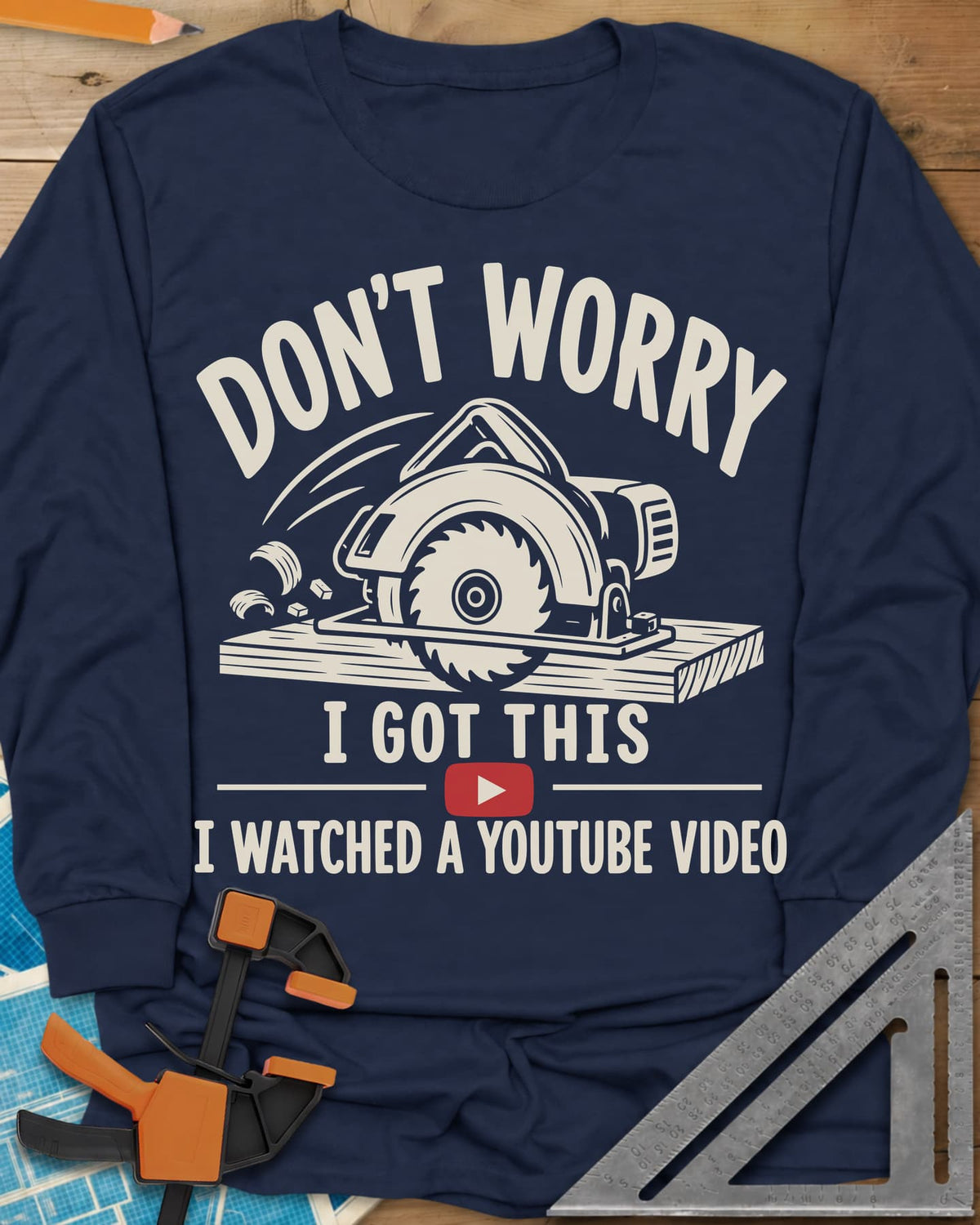 YouTube Pro long sleeve shirt in Navy, a circular saw cutting a plank with flying chips and a red play button