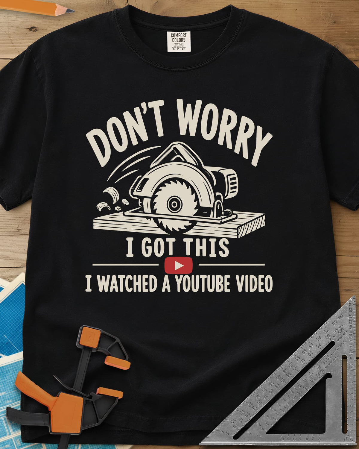 YouTube Pro heavyweight tee in Black, a circular saw cutting a plank with flying chips and a red play button