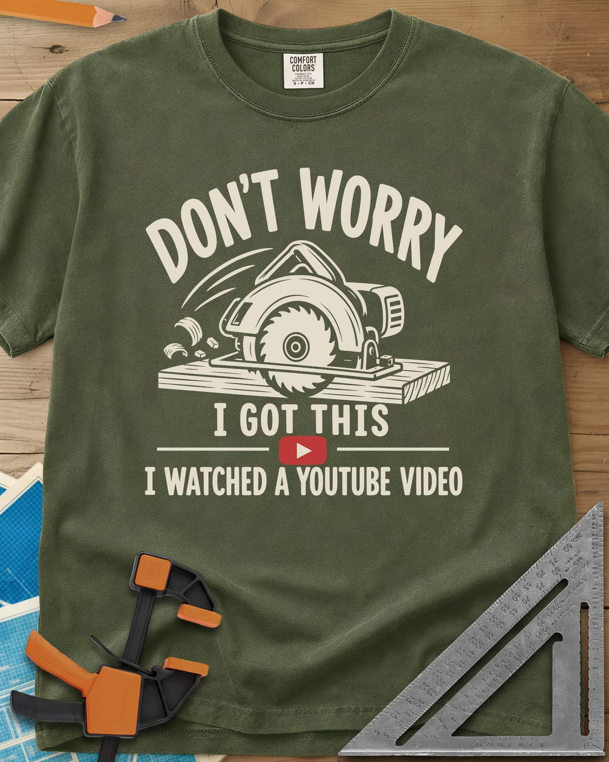 YouTube Pro heavyweight tee in Hemp, a circular saw cutting a plank with flying chips and a red play button