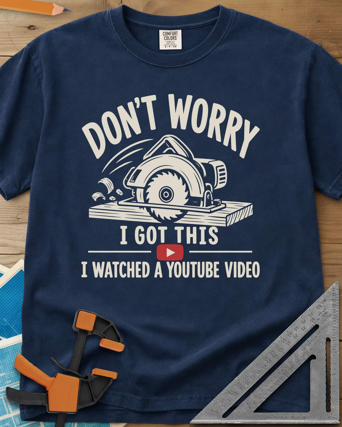 YouTube Pro heavyweight tee in Navy, a circular saw cutting a plank with flying chips and a red play button